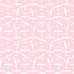 Scattered Vintage Airplane Silhouettes in White with a Baby Pink Background (Mini Scale)