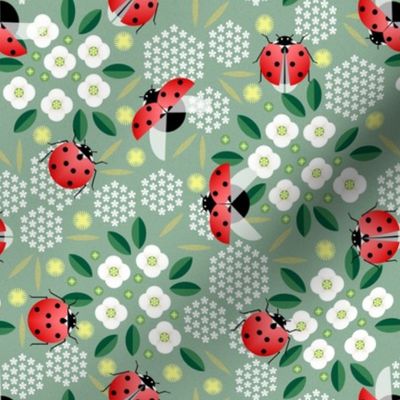 ladybugs and flowers on green