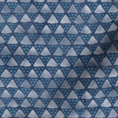 Block Print Pyramid Triangles on Faded Denim | Hand block printed triangle pattern in turquoise and white on blue gray denim.