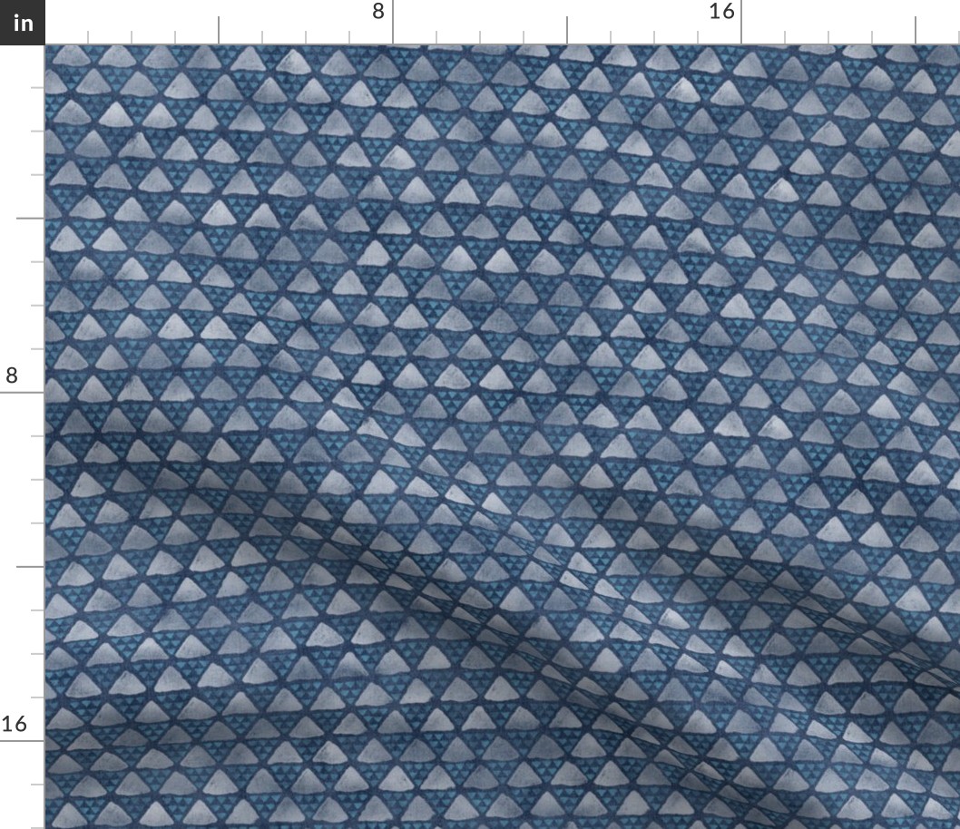 Block Print Pyramid Triangles on Faded Denim | Hand block printed triangle pattern in turquoise and white on blue gray denim.