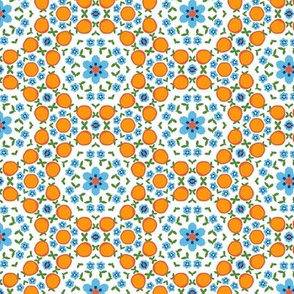 oranges with blue flowers on white