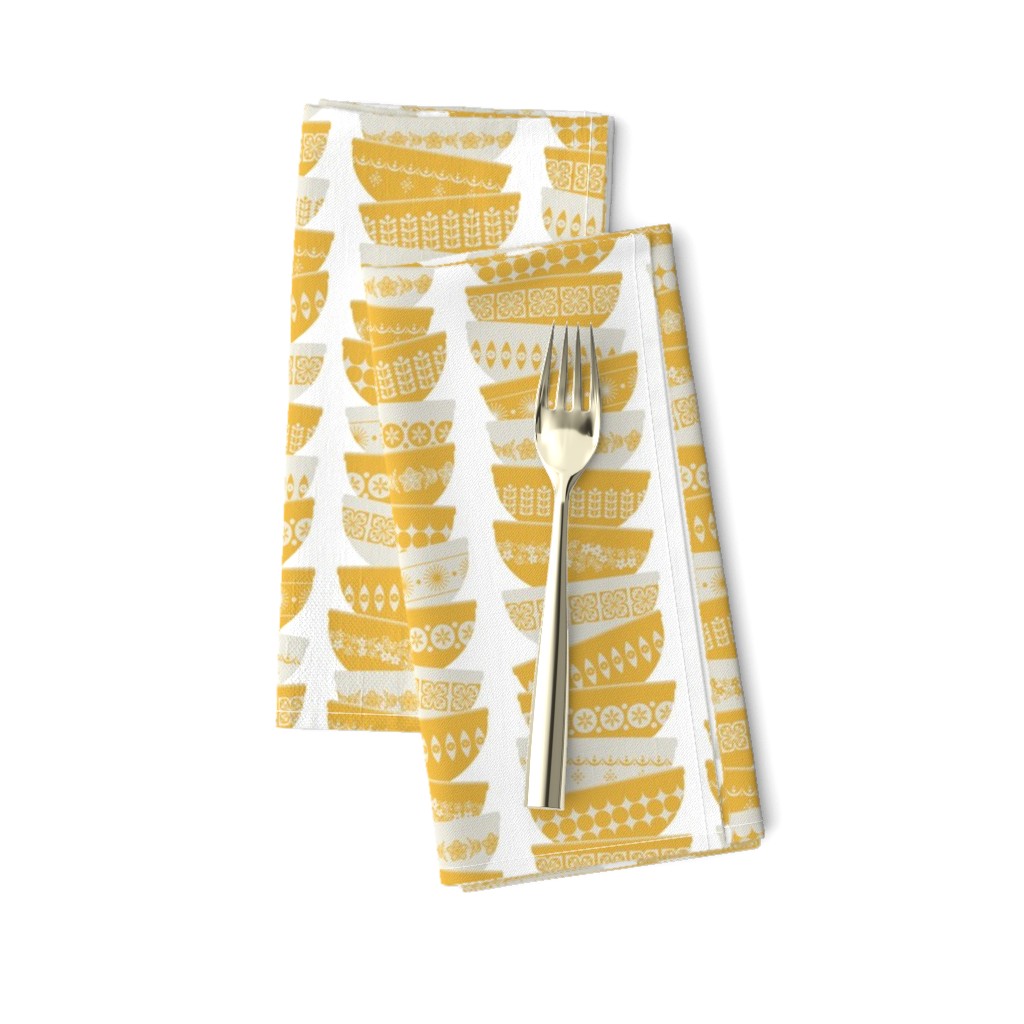 stacked daisy yellow pyrex bowls - white background - small