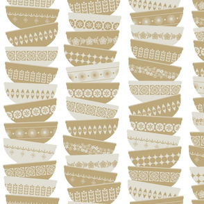stacked tan pyrex bowls - white background