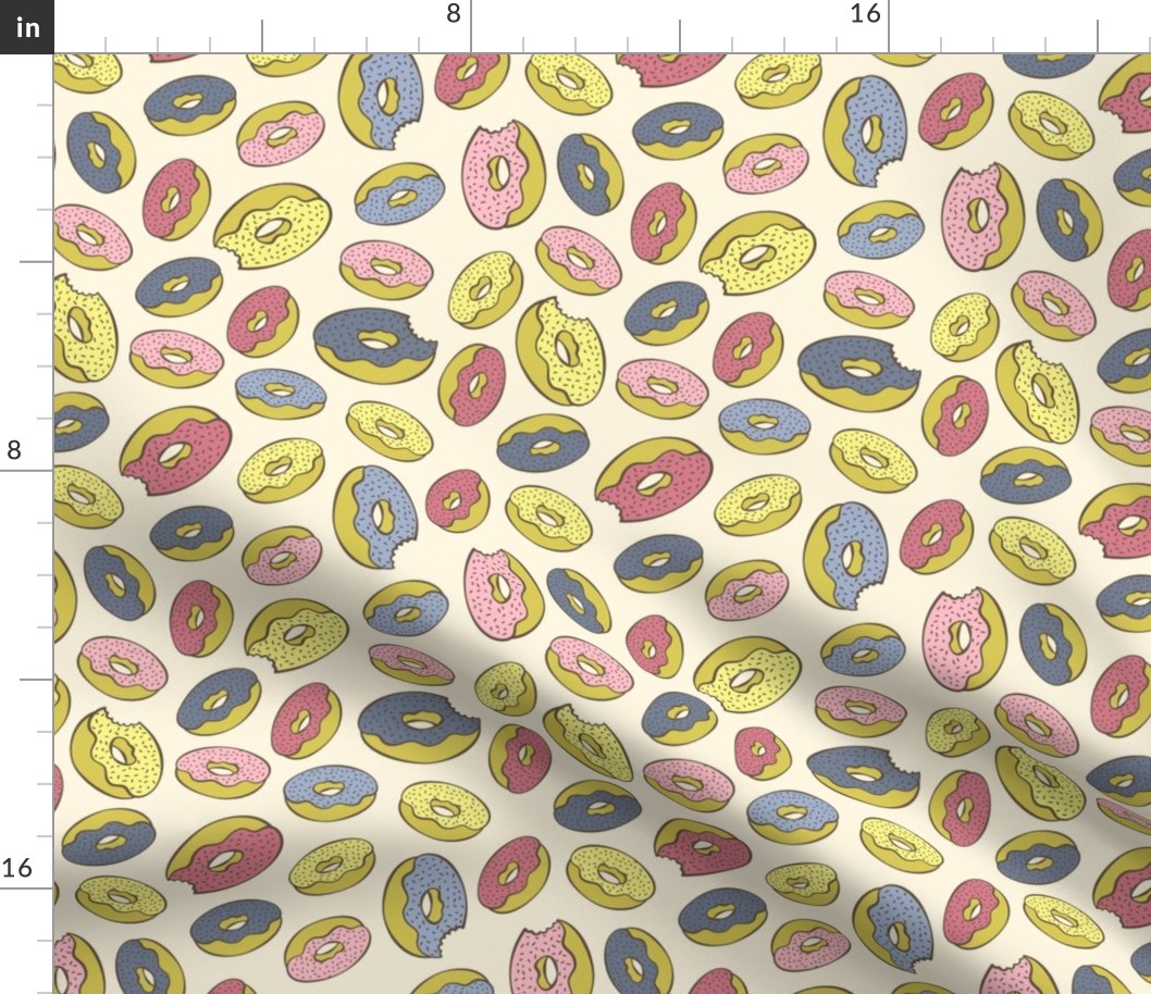 Pink, blue, yellow doughnuts (donuts), creamy yellow background