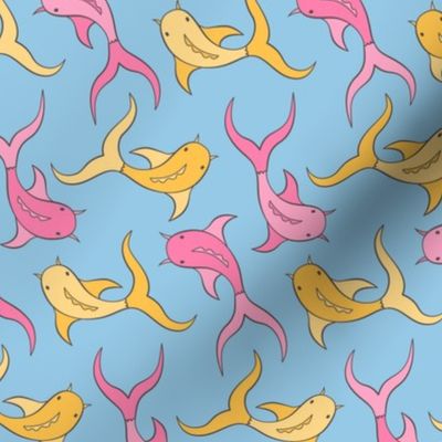 Pink and yellow koi fish swimming on blue background
