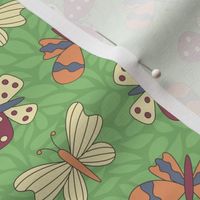 Cranberry red, orange, slate blue, and yellow butterflies, leafy green background