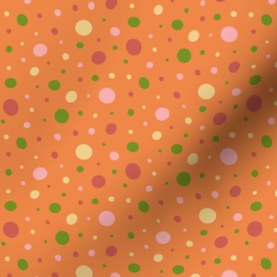 Pink, red, green, and yellow dots on an orange background