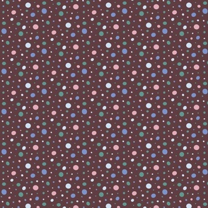 Pink, gray, jade green, and blue dots on a brown background