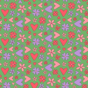 Cute pink, lavender, and salmon hearts and flowers on a green background