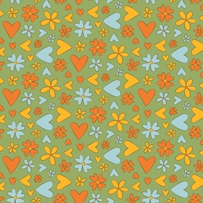 Cute blue, orange, and yellow hearts and flowers on a green background