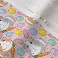 small bunny guinea pigs eggs and carrots on pink