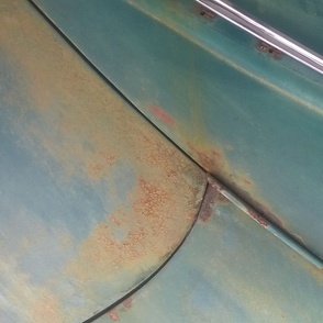 Patina on old car closeup with kaleidoscope repeat blue mustard chrome
