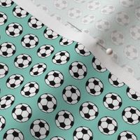 Soccer balls on turquoise