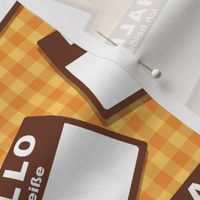 Scattered German 'hello my name is' nametags - brown on yellow/orange gingham
