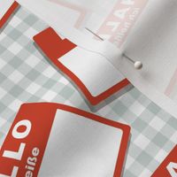 Scattered German 'hello my name is' nametags - red on grey gingham