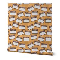 Scattered Japanese 'hello my name is' nametags - brown on yellow/orange gingham