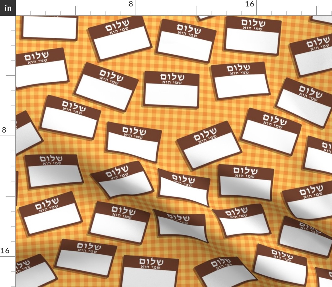 Scattered Hebrew 'hello my name is' nametags - brown on yellow/orange gingham