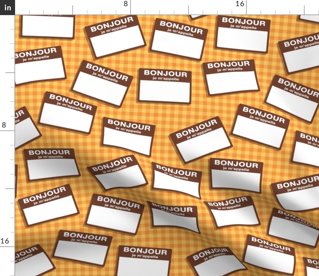 Scattered French 'hello my name is' nametags - brown on yellow/orange gingham