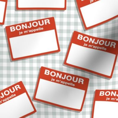 Scattered French 'hello my name is' nametags - red on grey gingham