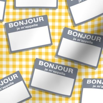 Scattered French 'hello my name is' nametags - grey on yellow gingham