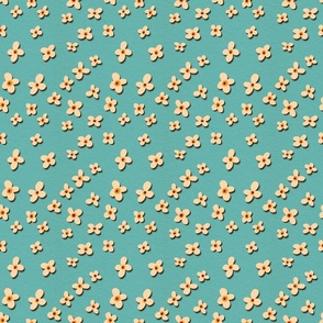 Tossed cream cut out flowers on turquoise background