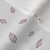 Blush pink hand-stamped tiny leaves tossed on white smoke background