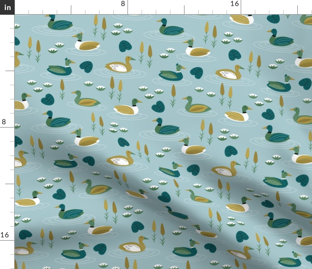 Little ducks swimming in a pond with lilies and riet spring animals minty blue green