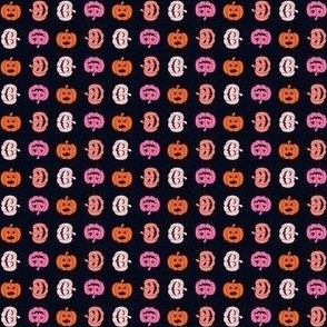 Tiny halloween jack o lanterns in pink and orange on black