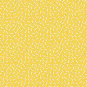 Tiny dog bones on yellow 