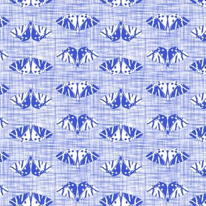 jersey tiger moths on blue linen texture