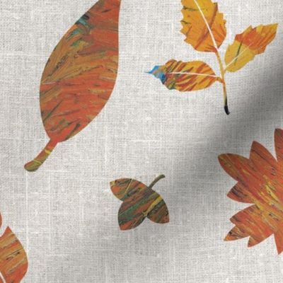 Falling rusty autumn leaves on grey linen