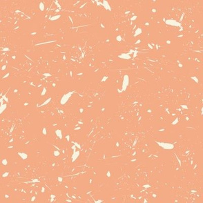 Splashes and scratches in beige on apricot