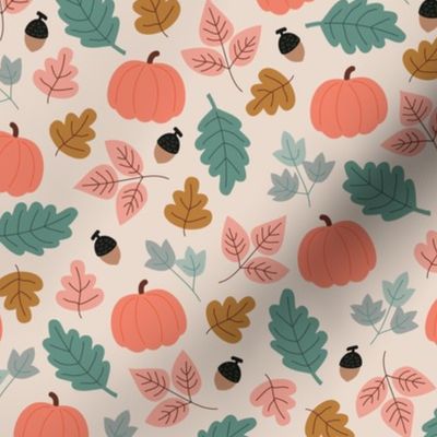 Fall forest leaves and pumpkin fruit acorns and branches pink green cinnamon on beige sand 