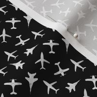 White airplanes on black - tiny scale - watercolor planes for travel inspiration