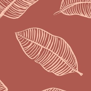 The jumbo banana leaf tropical boho leaves  jungle design for summer pink blush on stone red