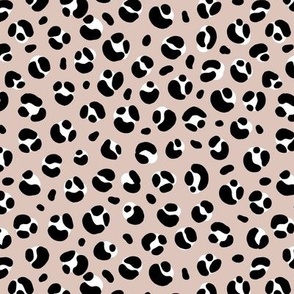The bold leopard design animal print panther spots black and white on beige latte sand