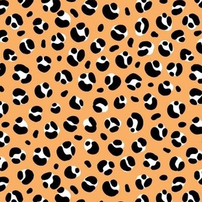 The bold leopard design animal print panther spots black and white on honey orange