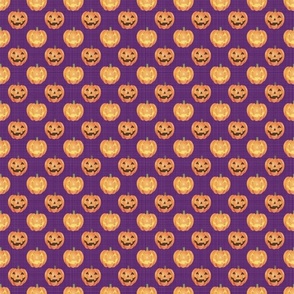 small scale jackolantern pumpkins on purple texture