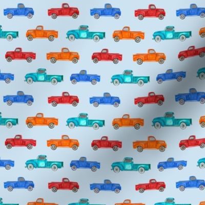 Small Scale Colorful Vintage Trucks  on Light Blue