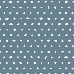 White hand drawn dots on blue background