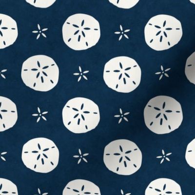 Medium Scale Sand Dollars on Navy Blue Ocean Water Background 