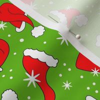 Medium Scale Red Santa Hats and Snowflakes on Green