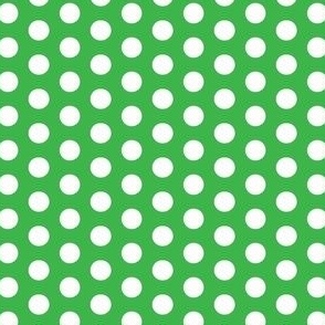 White polka dots on a green background 