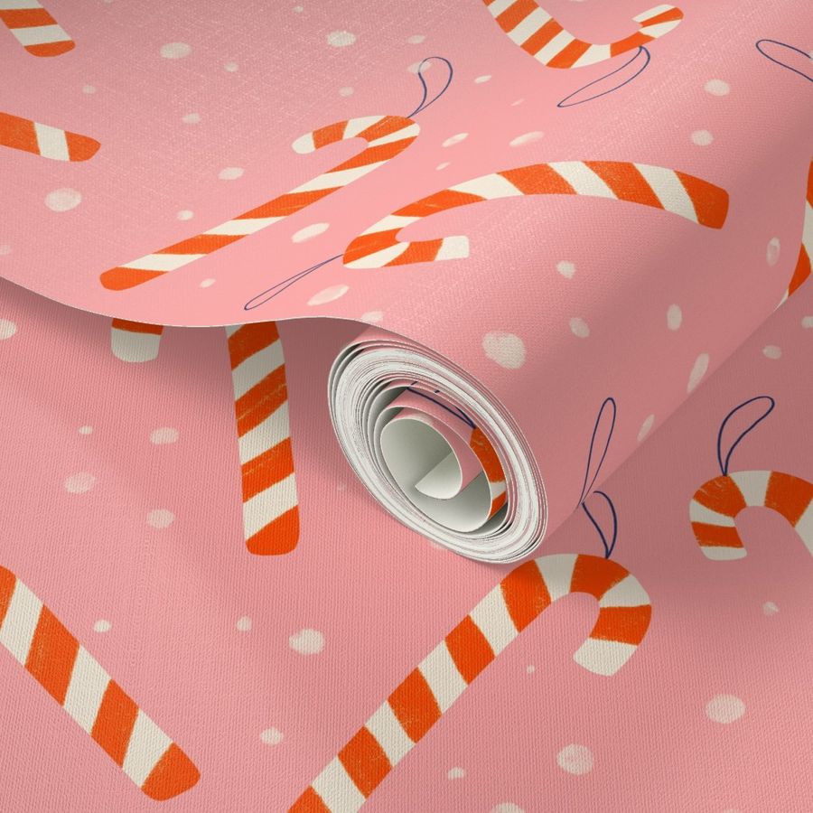 Christmas candy canes on pink background