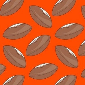 Footballs on orange background