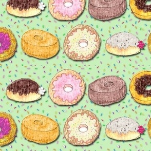 Donuts on green with sprinkles