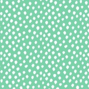 White spots on light teal green