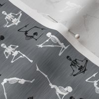 Smaller Scale Yoga Skeletons Exercising Stretching Black and White Halloween Skeletons on Grey Texture 