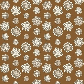 Decorated Gingerbread Snowflake Cookies on Ginger Brown Background