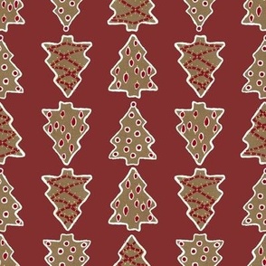 Decorated Gingerbread Christmas Tree Cookies in a Row on Deep Red